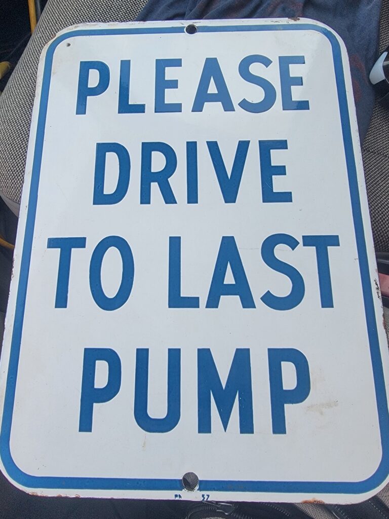 Please Drive to Last Pump Sign